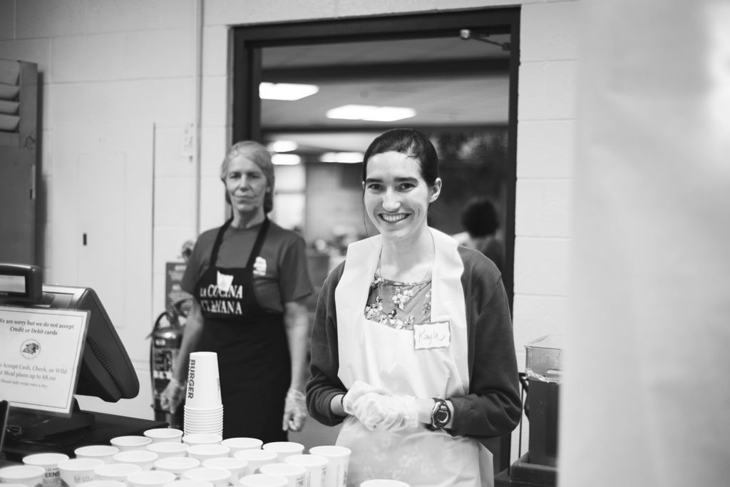 North Wind file photo: Right, NMU alumna Kayla Argeropoulos volunteers with a smile at the annual “First Nations Food Taster” event last year.