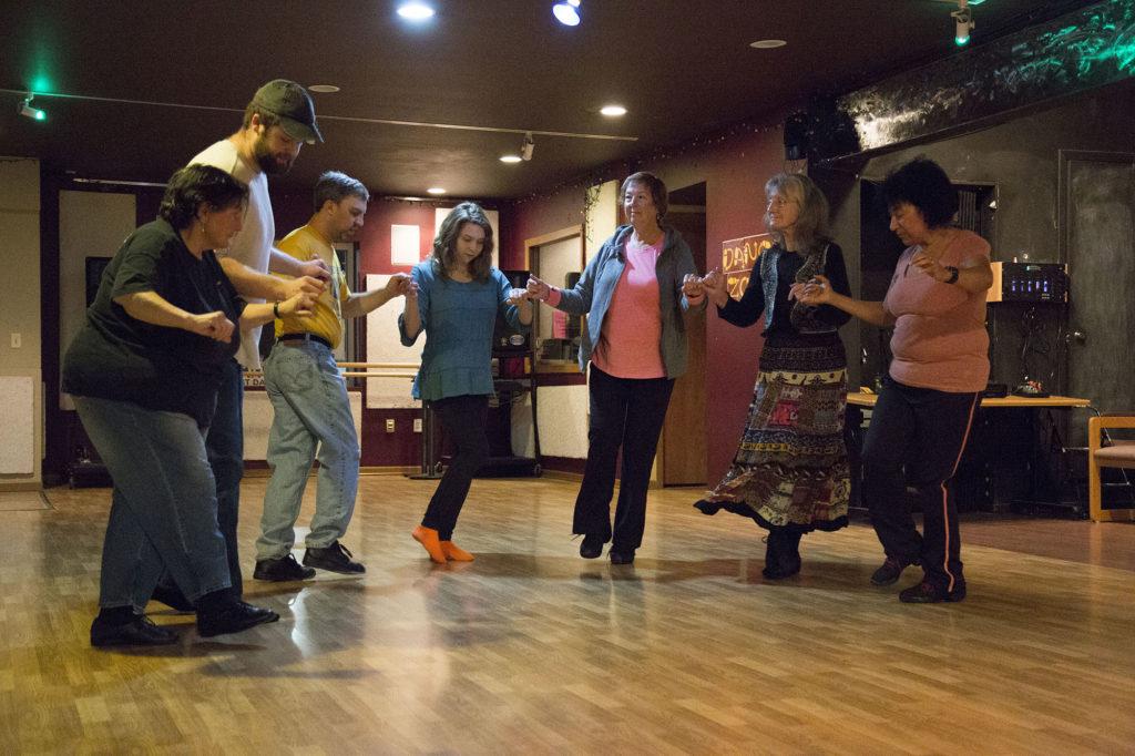 Photo by Neil Flavin: The International Dance Club circles up for a round dance on Tuesday evening at the Dance Zone in Marquette.