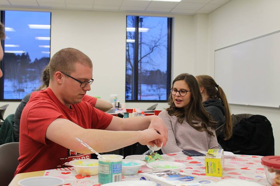 Community member Sam Bradbury decorates cookies as part of the Best Buddy program to build friendships between students and people with intellectual and developmental disabilities, to increase awareness about issues that affect them and to foster understanding among people.
Photo courtesy of NMU Best Buddies