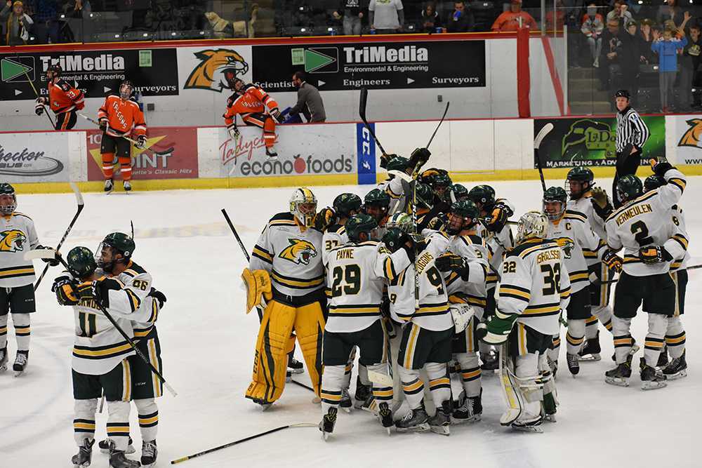 Members+of+the+Wildcat+hockey+team+celebrate+at+center+ice+after+winning+3-2+in+OT+Sunday+night+at+the+Berry+Events+Center.+Junior+forward+Adam+Rockwood+and+sophomore+forward+Demico+Hannoun+embrace+in+the+bottom+left+as+the+rest+of+the+team+swarms+the+overtime+hero%2C+junior+forward+Troy+Loggins.%0APhoto+by%3A+Lindsey+Eaton%2FNW