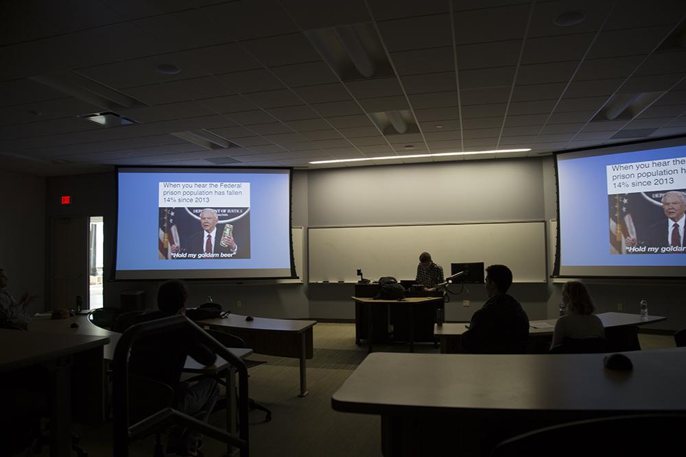 Students listen to political science professor Hanna Kassab as he explains his observations regarding memes in politcal culture.
Photo by: Neil Flavin