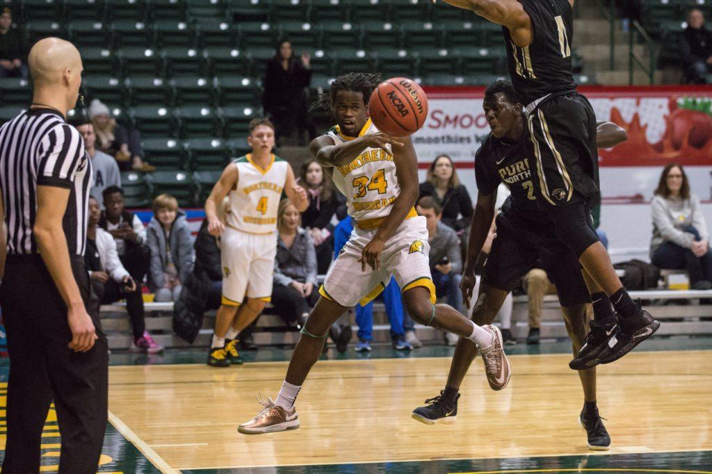 Junior guard Sam Taylor’s court-vision psyches out two Purdue-Northwest University defenders in a previous matchup this season. Taylor is expected to return next season as a lead point guard.

Photo courtesy of NMU athletics
