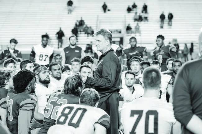 Head Coach Kyle Nystrom talks to his team after a hard-hitting day of practice.

Photo courtesy of NMU athletics
