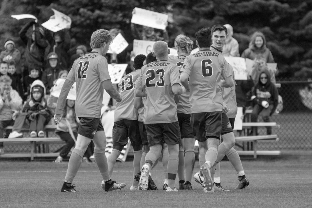 The+team+celebrates+after+scoring+a+goal+in+a+game+last+fall.+Photo+courtesy+of+NMU+athletics.+