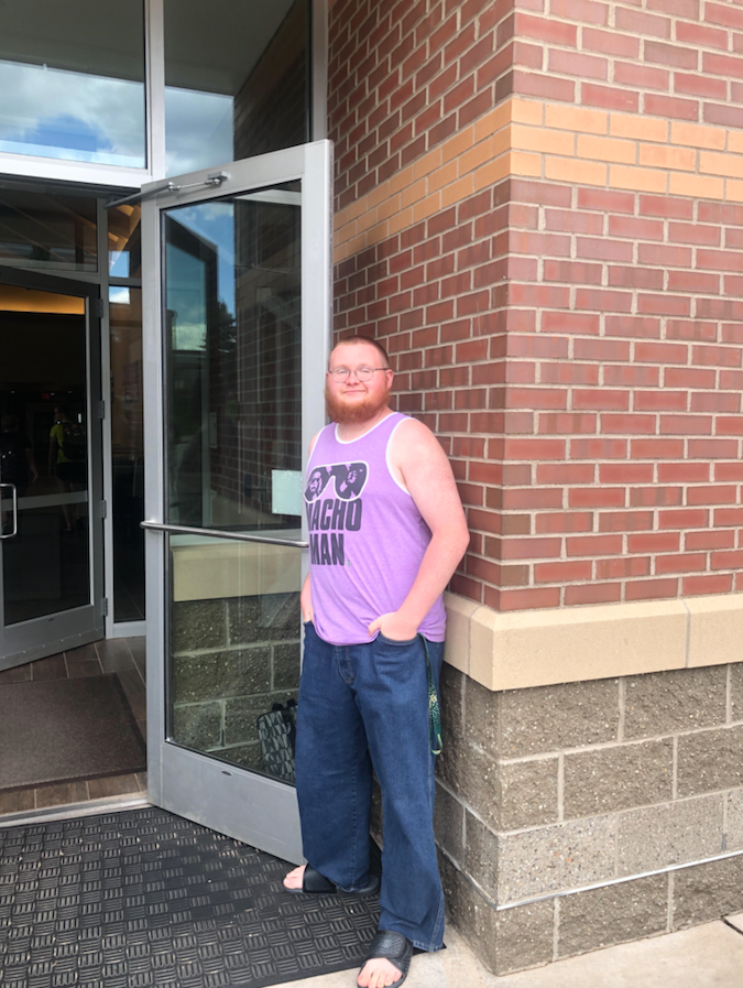 KILL ‘EM WITH KINDNESS—To brighten everyone’s day, freshman history major R.J. Coon holds the door at the entrance of the Lodge connected to the Woods for fellow students and faculty.
Denali Drake/NW