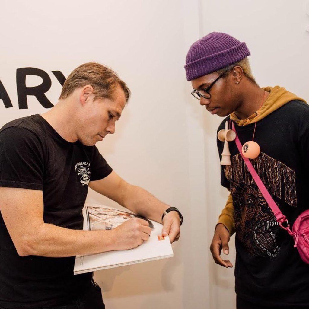 THAT JOHN HANCOCK—On the 2018 trip to Pasadena, California, the Anchor Point students met Shepard Fairey the designer of the Obama Hope poster. Junior graphic communications major Ali Davis was able to snatch an autograph upon meeting the famous designer. 
Photo courtesy of Anchor Point Instagram