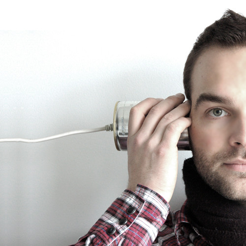 man listening through a tin can