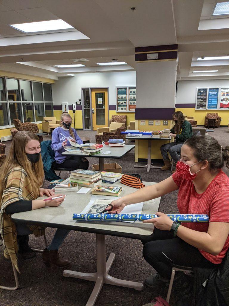 Katarina Rothhorn/NW

BOOK DATE - Elizabeth Mansfield (front left), Veronica Line (front right), Mandy Joslyn (back left), Megan Romkema (back right)are members of the Mortar Board and are wrapping up books on March 1 for the second week since the first week they almost sold out of all the books. 