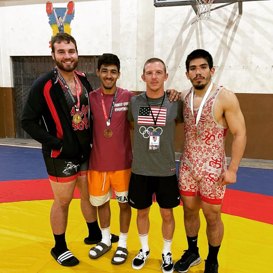 SUCCESS OUTSIDE THE U.S.—NMU Greco-Roman Wrestling volunteer assistant coach Paul Tellgren poses with the three medalists Maxwell Diaz, Diego Romero and Jovan-Antonio Mercado. All three took home medals at the Eduardo Campbell Cup in Santiago, Panama on September 4. Photo courtesy of Paul Tellgren.