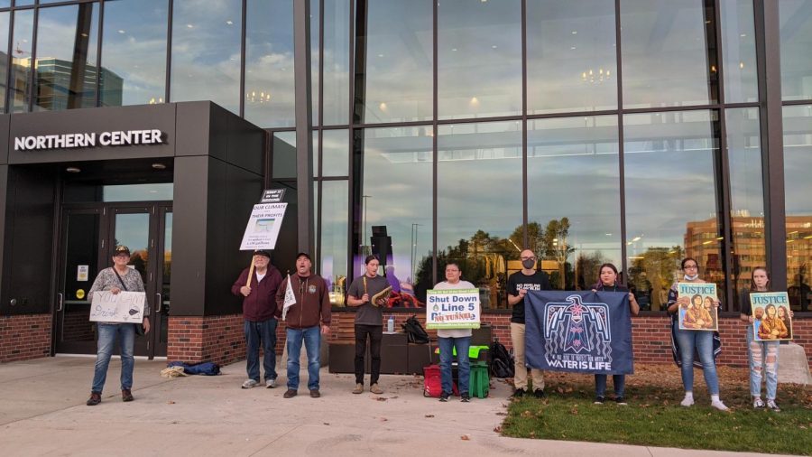 TAKE A STAND—Students, professors and community members gathered in front of the Northern Center on Oct. 19 to protest Enbridge's harmful Line 5. The protest was organized in part by NMU professor Martin Reinhardt.