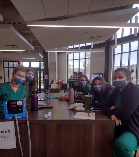 GIVING BACK—Morgan Hallenbeck (left, front), Loryn Burnette (farthest back, right), Lauren Smith (middle, right), and Analisa Ehli (front, right) Students from the School of Nursing helped out with the Blood Drive by taking vitals for those who were donating blood.