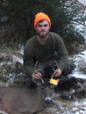 BIG BUCK CHASE—NMU student Travis Bessner poses with one of his two bucks last year. Bessner said that he was lucky to get two a year ago, and time will tell if others can be as lucky this year when the season begins on Monday.