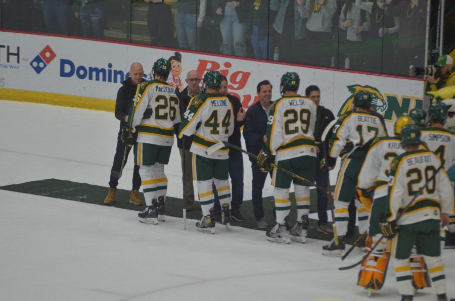 A+GREAT+HONOR%E2%80%94The+current+NMU+team+meets+with+the+six+former+members+of+the+1991+national+championship+team+who+attended+during+the+first+intermission+on+Saturday+night.+NMU+defeated+Boston+University+6-2.+Travis+Nelson%2FNW