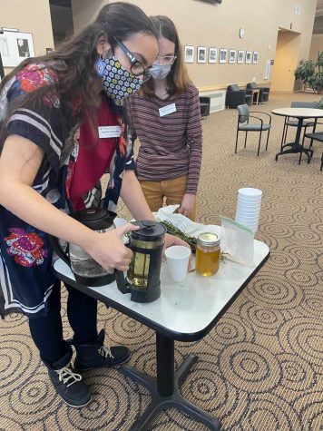 Kateri Phillips serves sweet fern tea to participants at the Enlightenment of Indigenous Foods event. The goal of the event was to increase awareness around Native foods and their importance in Native culture.