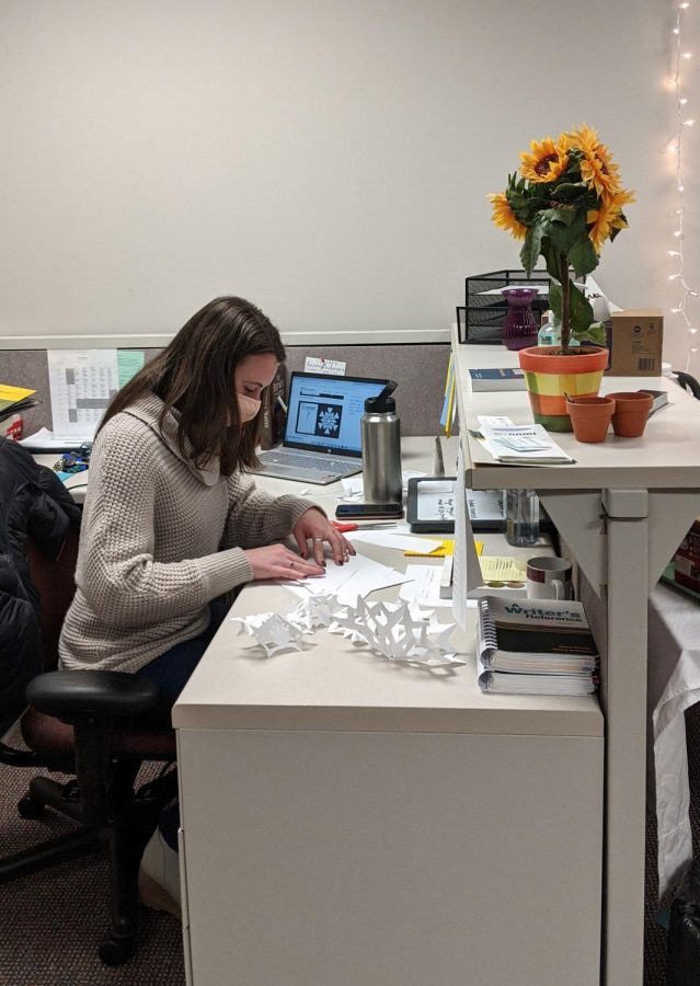 Rachel Hauch creates paper snowflakes to hang up as decorations for the write-in on Tuesday and Wednesday. The write-in is designed as a time for students to work on their final papers in a fun and productive environment, but also as a way to inform students about the location of the Writing Center.