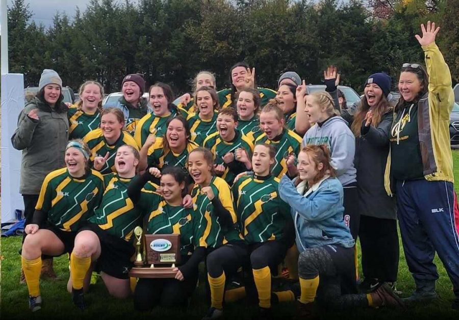 TWO WINS AWAY—The NMU Northstar womens rugby celebrates with their regional championship trophy after a lopsided victory against Minnesota State-Moorhead. The team now heads to Tennessee to face Wayne State College in the national semifinals, and are two wins away from winning it all. Photo courtesy of Rachel Placeway.