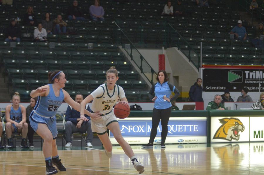 ONE SHOT SHORT—NMU forward Vivianne Jende drives to the rim for a lay-up in the first quarter of the Wildcats 78-75 loss to Northwood on Saturday. Jende was on fire early with 10 first quarter points, and finished second in scoring for the Cats with 14. Travis Nelson/NW