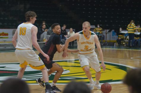 WINNING WITH OFFENSE—NMU guard Nick Wagner drives to the basket being guarded by Jarrin Randall in the Wildcats 91-79 win over Davenport. Northern has now won four of its last five games since the beginning of the new year. Travis Nelson/NW