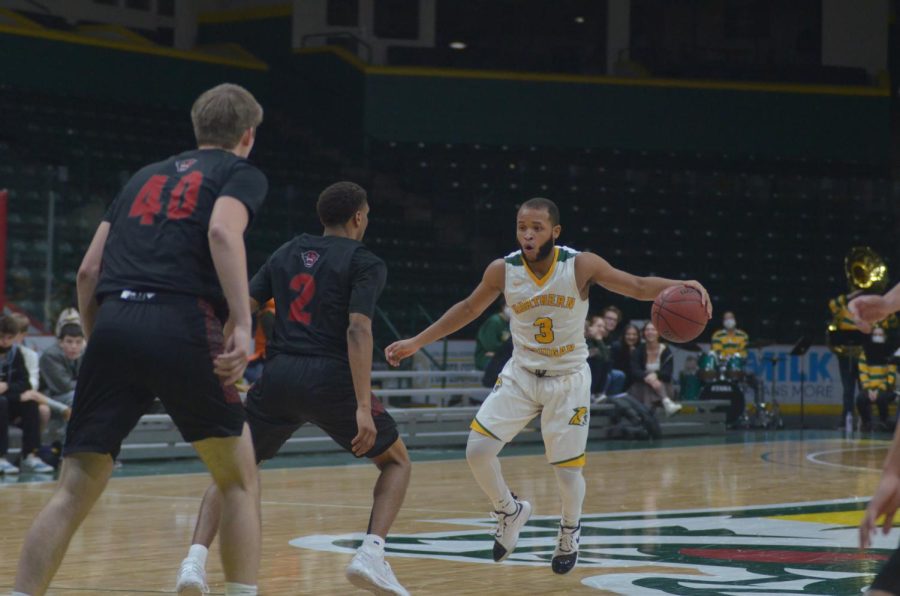 RUNNING THE SHOW—NMU point guard Justin Brookens looks to attack the Davenport defense during the Wildcats 91-79 win over the Panthers on Thursday night. Brookens will have a big role to play if the Cats want to continue their recent successes. Travis Nelson/NW