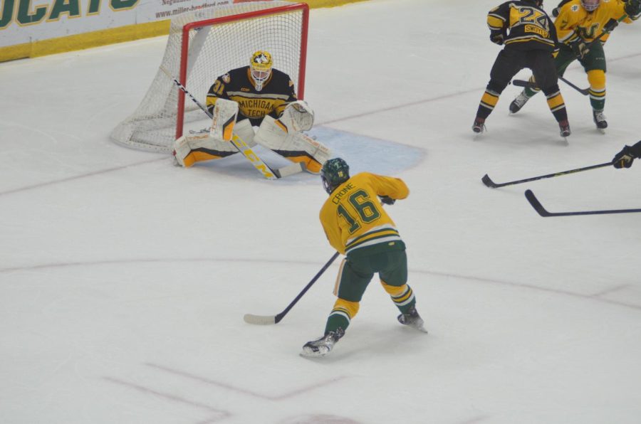 RIVALRY POSTPONED—NMU forward Hank Crone scores a goal against Michigan Tech goaltender Blake Pietila on Saturday, Nov. 13 in the teams last meeting. This weekends series between the two teams has been postponed, and both schools are attempting to re-schedule the series for later in the season. Travis Nelson/NW