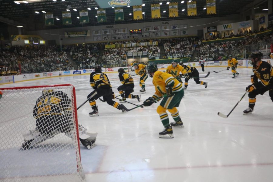 SAYING GOODBYE—Joseph Nardi and Ben Newhouse sharing the ice together back in November against Michigan Tech. The two senior captains careers are coming to an end soon. Photo courtesy of NMU Athletics.