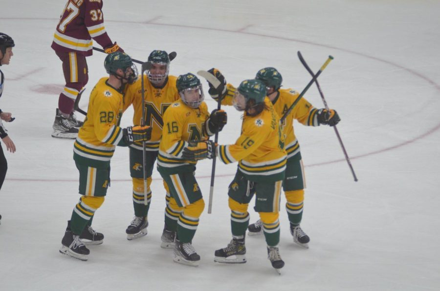 STAYING ALIVE—The NMU hockey team celebrates a goal earlier this season. The Wildcats season continues onto Mankato for a CCHA semifinal game this weekend after they dispatched Lake Superior State in the first round. 