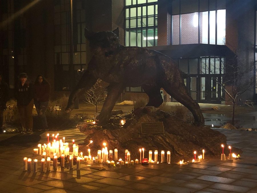 REMEMBRANCE—Students and faculty left candles around the wildcat statue for a silent vigil.