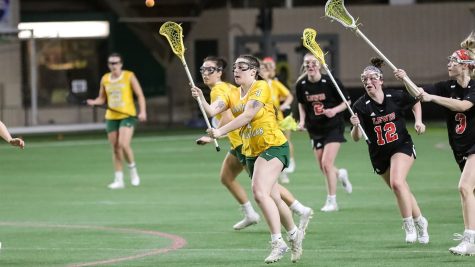 WINNING STREAK — Freshman midfielder No. 4 Emily Radke and the NMU womens lacrosse team rides a historic start into a tough two-game home stretch, currently on the program’s longest winning streak of six games. Photo courtesy of NMU Athletics