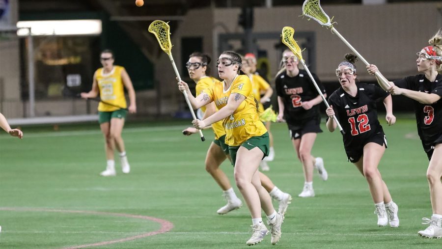 WINNING STREAK — Freshman midfielder No. 4 Emily Radke and the NMU women's lacrosse team rides a historic start into a tough two-game home stretch, currently on the program’s longest winning streak of six games. Photo courtesy of NMU Athletics