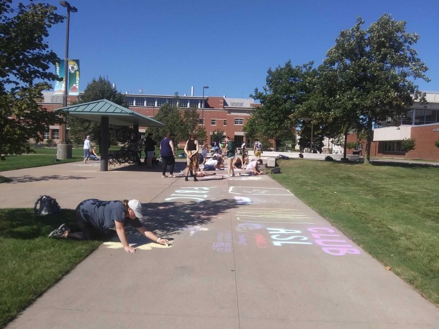 Students getting creative in the Academic Mall with chalk