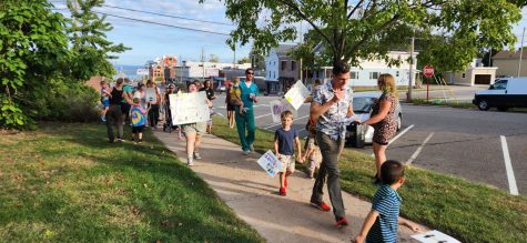 MARCH ON — Protestors and their children marched to raise awareness about a lack of childcare in the Marquette area. 