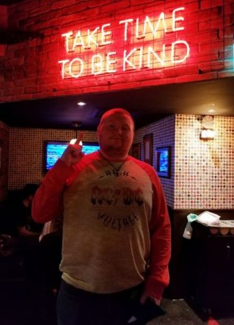 RJ Standing Below A Sign