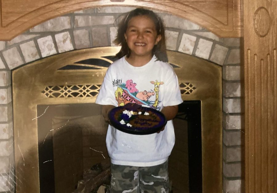ALL SMILES — A photo of me when I was 7 years old, giddily smiling with my choice of a cookie cake at my birthday party. When I was younger, my birthday felt like the best day of the year. Now, my birthday forces me to face the fact that I have no choice but to “grow up” and be an adult.