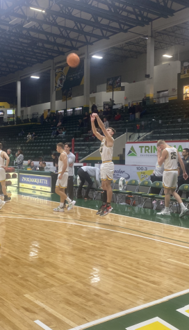 ON FIRE - NMU Guard Brian Parzych warms up at half time. Parzych scored 22 of his 30 points in the second half alongside teammate Max Bjorklands second 30-point or more outing of the season in just 3 games.