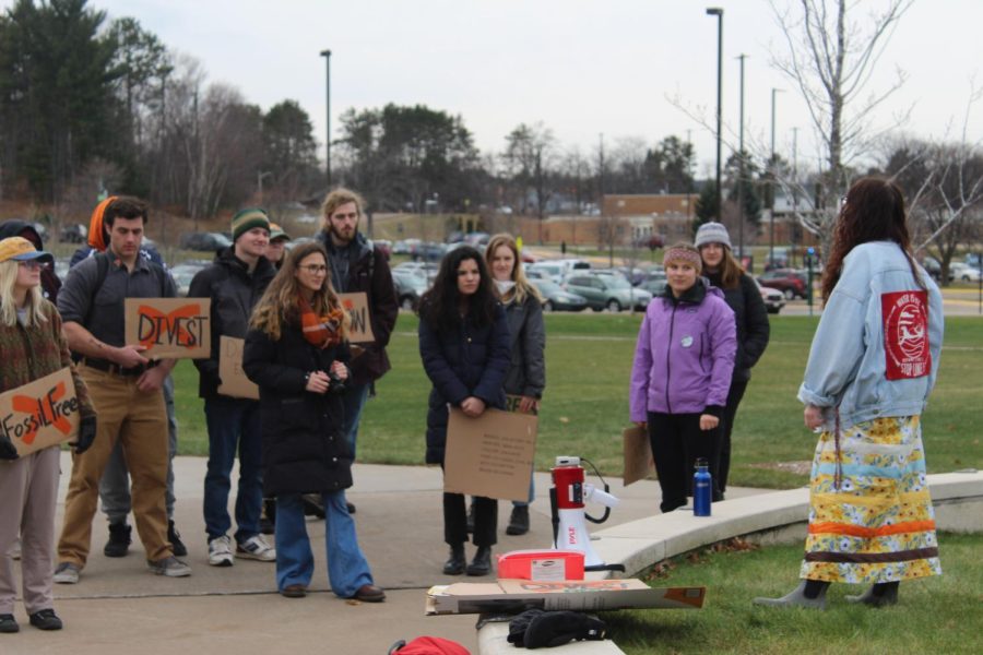 DIVEST - NMU students gather around the wildcat statue during the protest against fossil fuels.