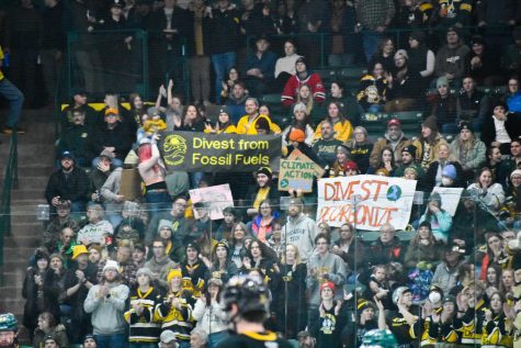Divest NMU and the Keweenaw Youth Climate Action Group of MTU protest from their seats at the NMU vs MTU hockey game this Saturday at the Berry Events Center. The club has been advocating for NMU to phase out its investments in the fossil fuel industry and reinvest in sustainable projects since October 2021.