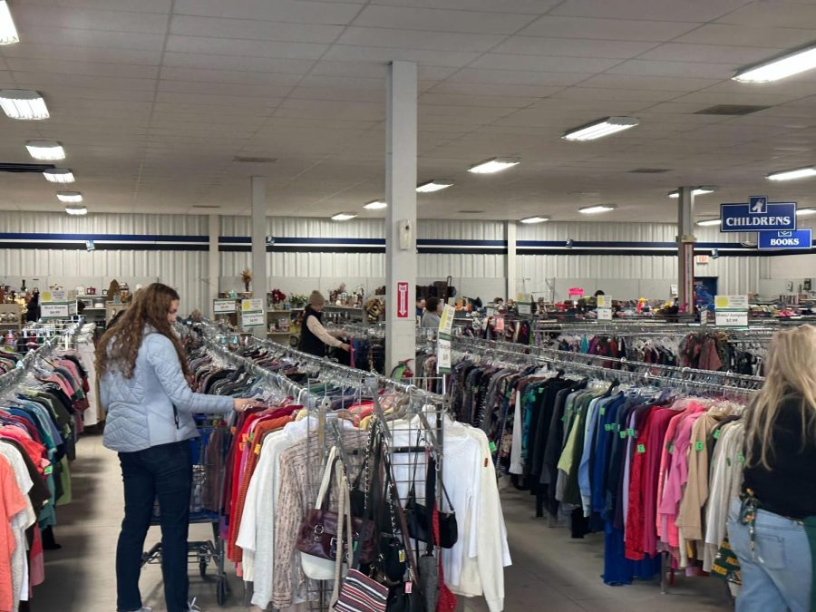 TRASH+OR+TREASURE+%E2%80%94+Customers+flip+through+racks+of+clothing+at+the+Marquette+Goodwill.+Not+only+is+thrift+shopping+an+incredibly+relaxing+experience%2C+but+buying+items+second-hand+is+great+for+our+environment.