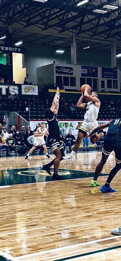 UP+AND+OVER+-+Star+NMU+guard+Max+Bjorklund+drives+to+the+basket+for+the+three-point+play+against+the+pride.+Bjorklund+had+24+in+the+game.