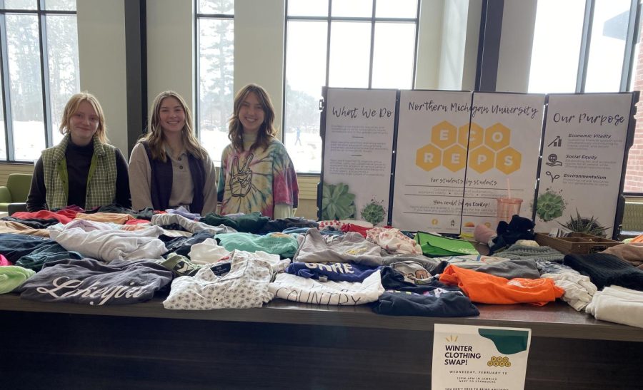REDUCING CLOTHING WASTE — EcoReps members Grace Freed, Cece Hogan and Miki Rogers (pictured left to right) volunteer at the Winter Clothing Swap hosted in Jamrich Hall. The swap provides students an alternative to fast fashion and encourages reducing and reusing clothing waste.
