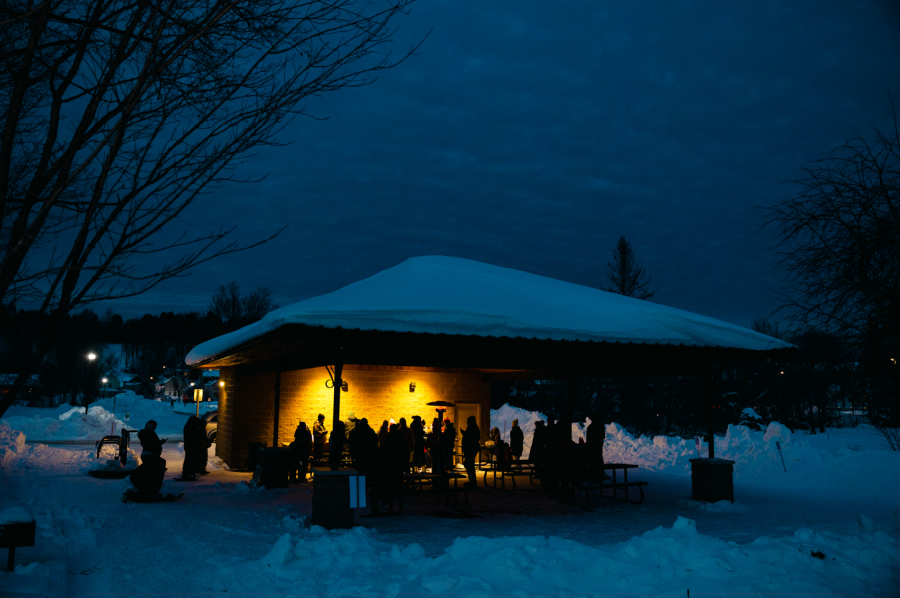 WARM AND COZY — People gather for hot chocolate and Trenary Toast after a snowshoe tour of Old Town Negaunee. 