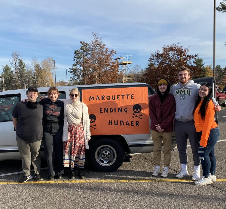 FUNDRAISING - Myers (far left) stands outside with volunteers promoting Marquette Ending Hunger. Myers said that the groups goals for each semester tend to be doing everything bigger and better, gaining more members, raising more money and providing more donations.