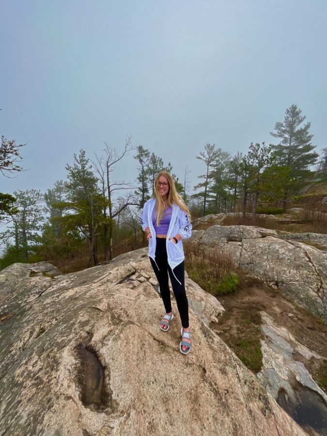HOME AWAY FROM HOME — NMU Senior Rylynn Sladek poses for a photo while on a hike in Marquette. Sladek has chosen to stay in the Upper Peninsula for the past two summers due to the variety of activities, from beach days to farmer’s market hauls, that the community has to offer.