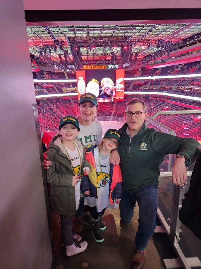 HOCKEY FANS — Tessman and his family at a Red Wings hockey game in March. They are still rocking the NMU gear in Detroit. 