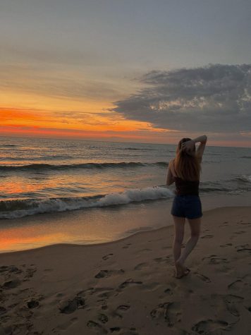 REFLECTIONS — I am posing at South Haven beach during sunset. With graduation approaching swiftly, I wanted to reflect on my college experience and how it has positively impacted my character and outlook on life.