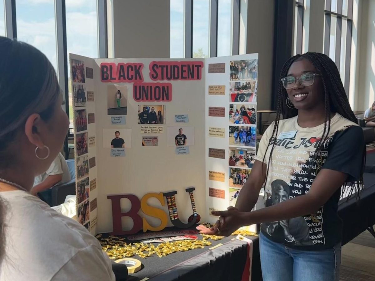 GETTING CONNECTED — MarLanaysia Rosser speaks with students about the Black Student Union during the Diversity Student Organization Fair. The fair was hosted in the Jamrich atrium to give diversity-centered student organizations a chance to meet with students in a smaller setting.