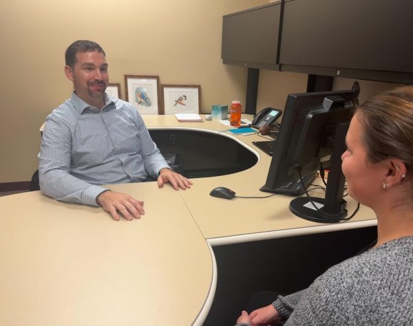 RESTRUCTURING ADVISING — Neil Baumgartner, Director of Student Success, discusses advising with a student. NMUs advising department, formerly known as ACAC, has been restructured as the Student Success Department in line with President Brock Tessmans university realignment plan.