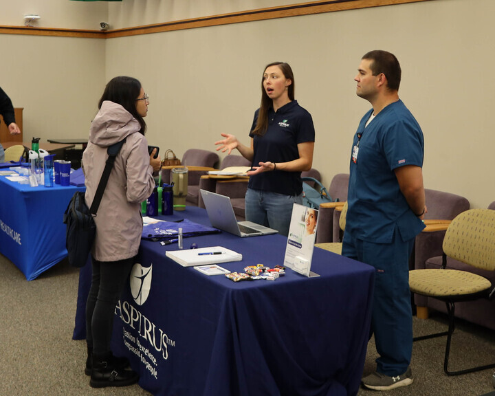 NURSING NETWORKING — Students talk with healthcare professionals during the Healthcare Career Fair hosted in the Whitman Commons. The fair allowed students to meet with employers and network for future career opportunities in the healthcare industry.