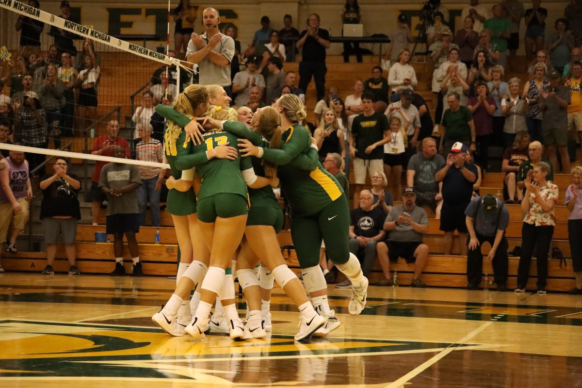 RELIEF - Cats celebrate a long-awaited win after starting the season 2-10, getting the 3-0 sweep against Michigan Tech.