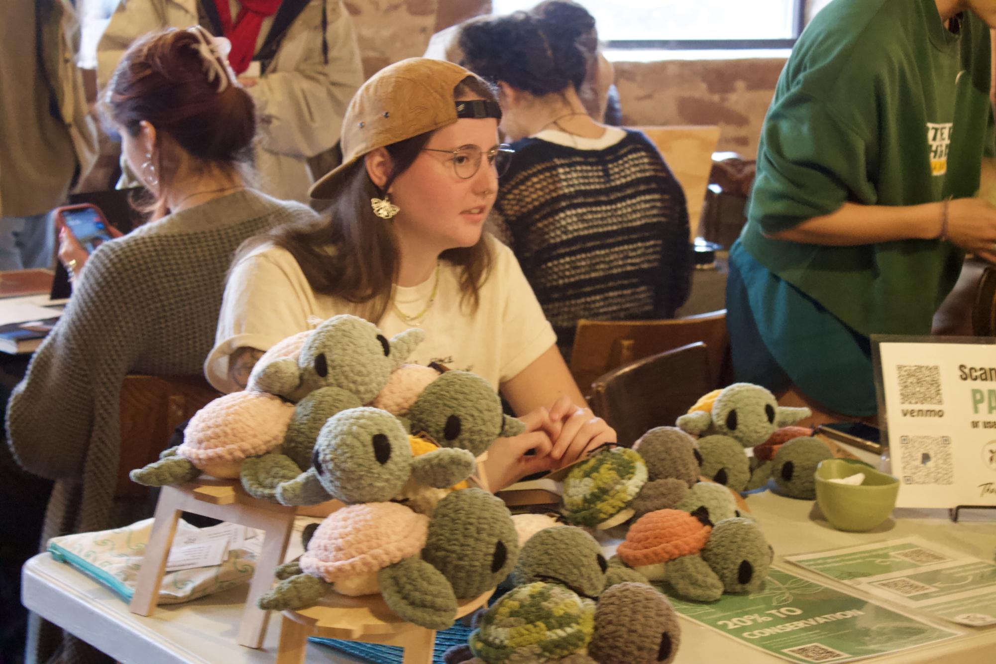 PILES OF ART — Senior Nicole Cash showcases her environmentally friendly crochet turtles in piles on her desk, hoping to sell many at the pop-up shop.