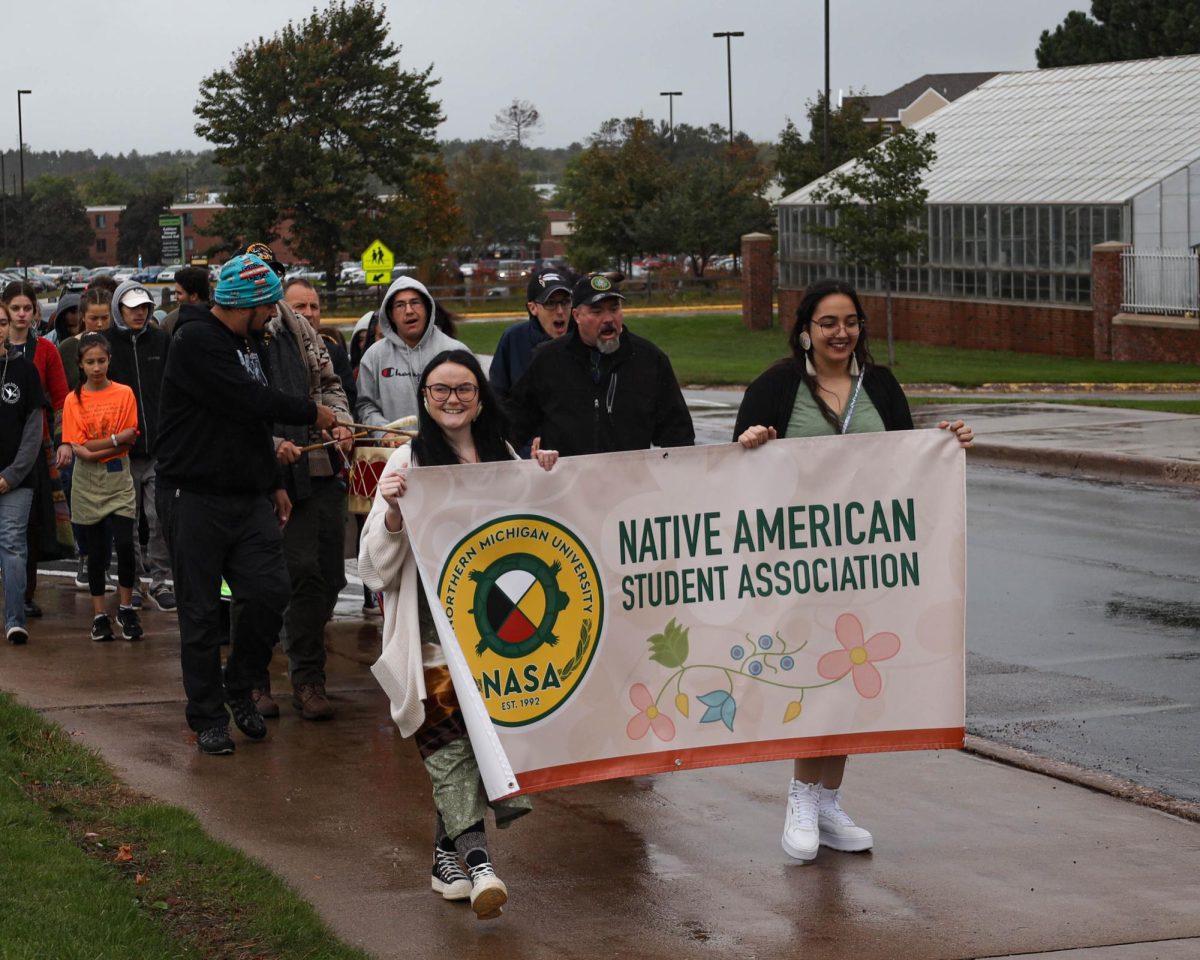 HEALING MARCH — NASA members, Shelby Boggs (left) and Kateri Phillips (right), lead a healing march during Indigenous Peoples Day celebration on Oct. 9.